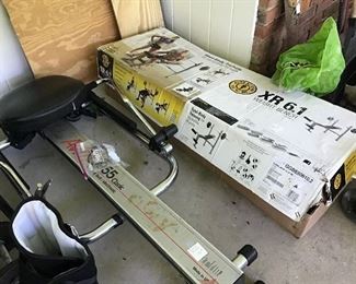 Rowing machine and unassembled workout bench