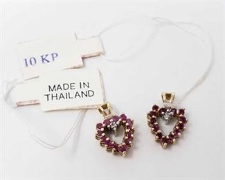 #124: Two 10k Gold Two-Sided Pendants with Diamonds and Semi-Precious Stones.
Weighs approx 2.1g