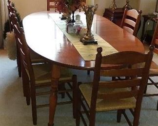 table set with 8 ladder back chair and rush seats. The table is pictured with the two leaves in. This set is in great shape. $175