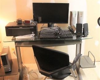Desktop computer, monitor, keyboards, scanner/printer and external speakers.  Also a nice glass top computer work table and chair!