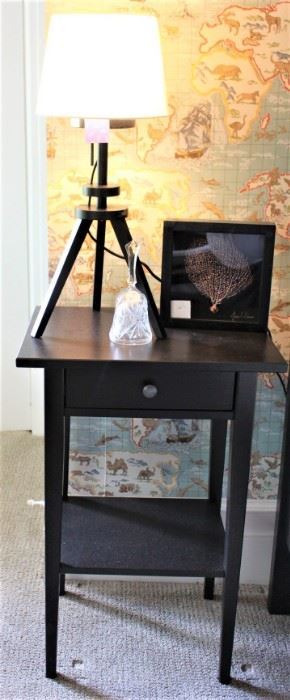 One of a pair of black end tables with a pair of lamps.  