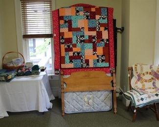 Linens, twin size bed shown with fun quilt.