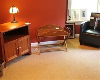 In this room we have a smaller end table, a tray coffee table and a black leather like chair.  