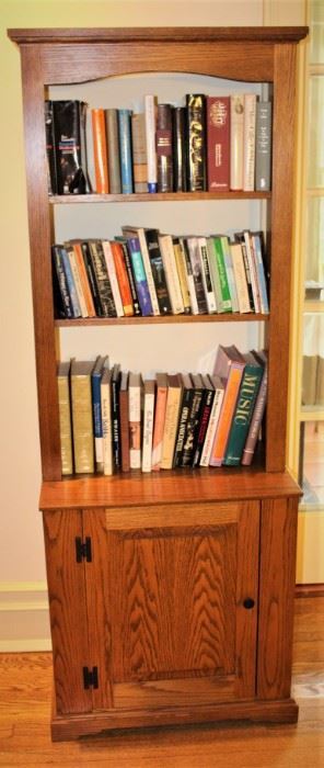 Nice size oak bookcase/cabinet filled with books.