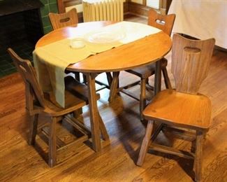Ranch/range oak table with four chairs.  Has additional leaves.  