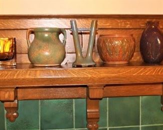 Mantel shown with vintage glassware and pottery pieces.  