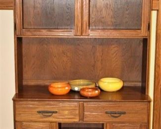 Ranch/range oak Brandt cabinet with glass cabinet doors on  top.