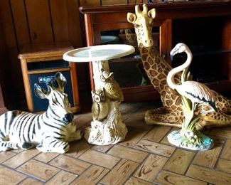 Statues.  Zebra, giraffe, flamingo.  Owl pedestal table