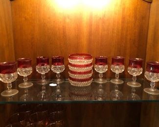 Clear to cranberry glass thumbprint goblets.  Bowls