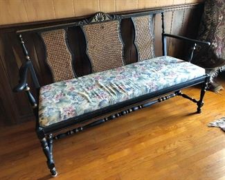 Tole painted, cane back bench.  Black and gold
