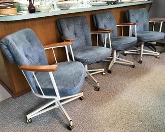 A set of four chairs on wheels. 
They go with the dining room table.