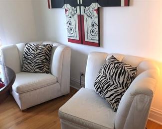 White upholstered chairs and put together becomes a small loveseat!
