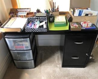 Black desk, metal file cabinet and plastic storage unit - office miscellaneous as well!