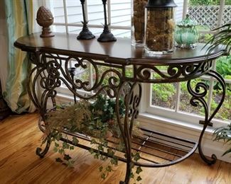 Ornate metal console table with wooden top