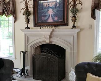 Pair of tole painted metal urns with feathers flanking a framed print above a tri-fold fireplace screen
