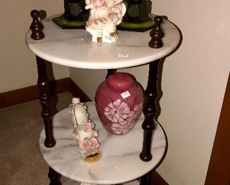 Three tier Marble top table with Fostoria candlesticks, tea caddy, mahogany blossom  and red letter Japanese brick brack