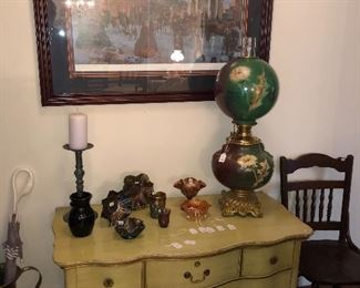 Large hand-painted dandelion GWTW Royal parlor oil lamp.  Ameythist carnival glass.  Distressed antique chest.  Antique chair, umbrella stand 
