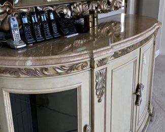 OMG this is an enormous credenza/cabinet with a marble top, and a mirror hung above this,  This could be used in any room of the house, but it sure is impressive