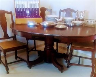 Mid Century Dining room table with 6 matching chairs, two leaves and matching China hutch