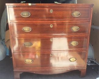 There are two of these mahogany four drawer chests. 