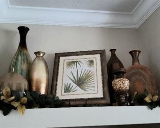 Various sizes of ceramic vases and Palm leaf wall art.  Magnolias greenery