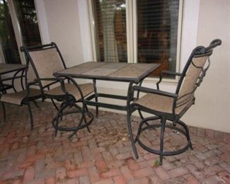 Pub height bistro patio set with tile top table and swivel chairs