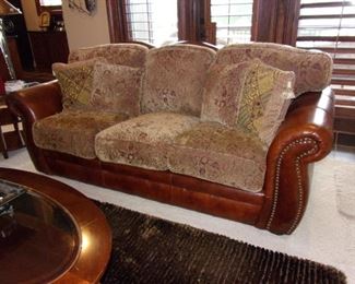 Leather rolled armed/nailhead trimmed Sofa/couch with matching chair and ottoman! Excellent condition! PLEASE NOTE PRINT FABRIC CUSHIONS ON SOFA ARE CUSTOM AND THIS SOFA COMES WITH ORIGINAL LEATHER COVER FOR CUSHIONS ON SOFA:)