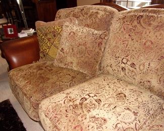 Leather rolled armed/nailhead trimmed Sofa/couch with matching chair and ottoman! Excellent condition! PLEASE NOTE PRINT FABRIC CUSHIONS ON SOFA ARE CUSTOM AND THIS SOFA COMES WITH ORIGINAL LEATHER COVER FOR CUSHIONS ON SOFA:)