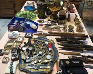 Interesting collection of tribal and hunting knives, watches, jewelry, and spears.