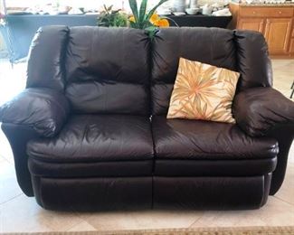 Brown leather reclining loveseat
