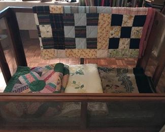 Vintage screened baby crib and handmade antique quilts. 