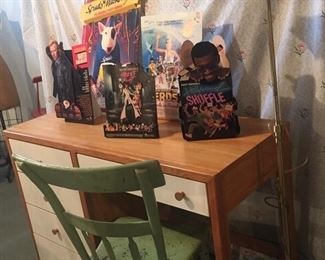 Student desk. Antique handmade shabby chic chair. Stand up ads for 90s movies: Revenge of the Nerds, Hollywood Shuffle, Wanted Dead or Alive, and a Spuds MacKenzie Budweiser ad.