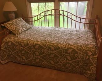 Trundle bed in blonde wood. Two twin mattresses. Comforter and sham.