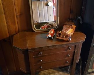 Antique sewing cabinet; mirror, vintage toy trucks