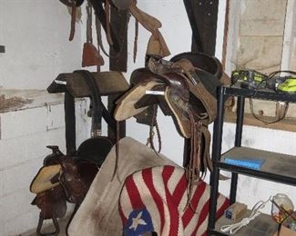 SADDLE RACKS AND 2 WESTERN SADDLES.