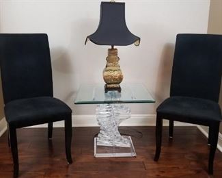 upholstered black chairs, decorative table and lamp