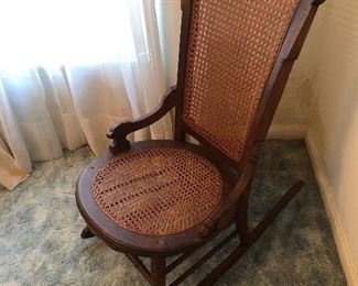 Antique rocking chair with can seat and back