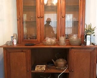 Wonderful display piece with glass shelves, glass doors, and storage cabinets and shelves on bottom