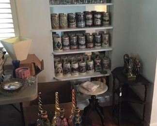 Many beer steins and collector glasses, along with other household items.