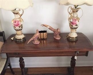 The side table, matching lamps, and pair of birds are shown here.