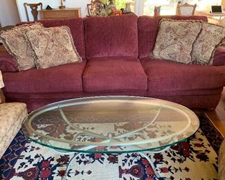 Beveled oval glass coffee table with rams head base