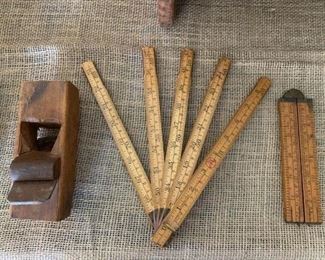 Antique wooden planer and two vintage folding yardsticks
