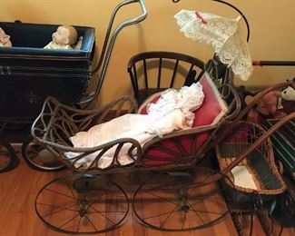 Vintage stroller -- wood with metal wheels.