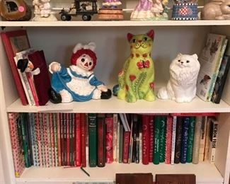 Selection of books, dolls, figurines of all types.
