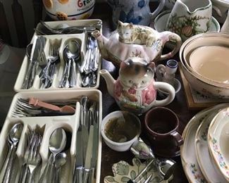 Kitchen packed. Many teapots, cookie jars, pitchers, silverware, etc.