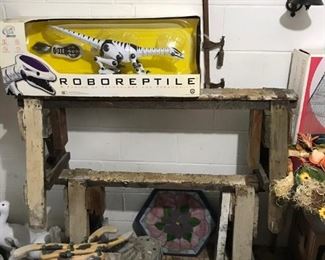 Boxed Roboreptile; sawhorses; small benches.