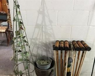 Two metal cone trellises; vintage croquet set.