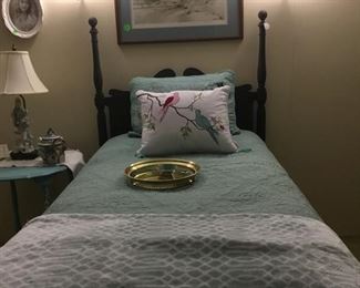 Black twin bed with mattress and box springs.  Has twin coverlet with throw. And dust ruffle.