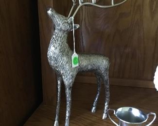 Silver deer with candle holders on antlers.