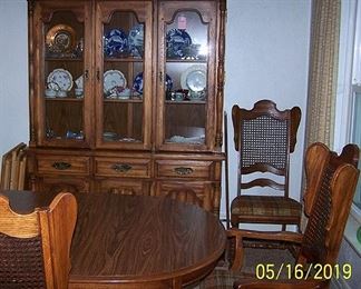 Dining room suite including table, 3 leaves, 2 Captain's chairs, six chairs and hutch.